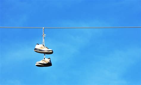 why are there shoes on power lines|shoes on telephone line meaning.